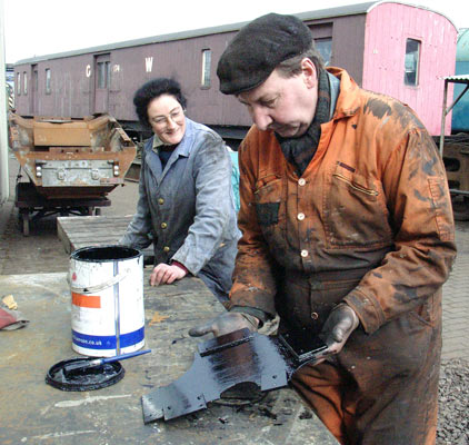 Alex Hayes (left) and Dave Fuszard worked on painting various pieces during the day. Here Dave has just finished a piece of backhead cladding. March 06 2004