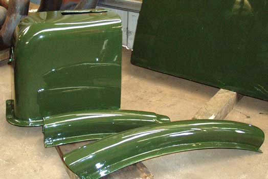 Having already received a top coat of paint, with more to come, some of the cladding pieces are starting to look fit for museum display. May 29 2004