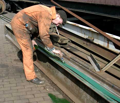 Dave Fuzzard paints the back surface of a boiler band. March 20 2004