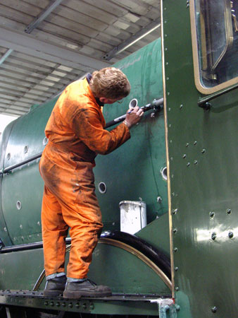 Kevin Blake applies primer to a few spots on a handrail. August 01 2004