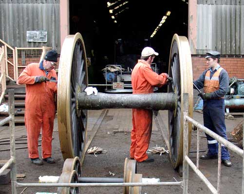 Scraping the old paint from the rear drivers are (from the left) Keith Clarke, Leon Salter and your webmaster. March 27 2004