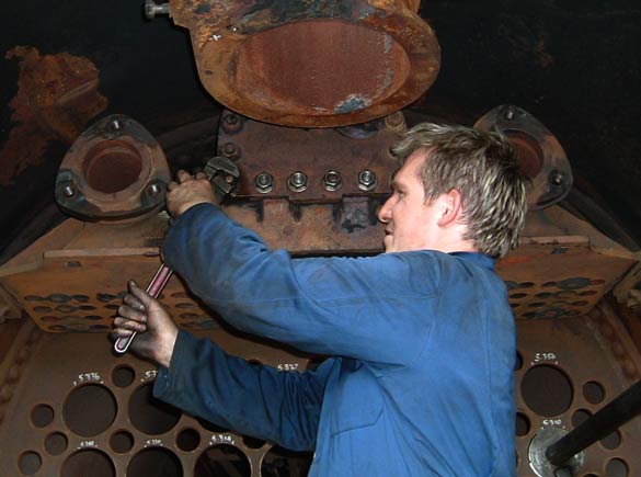 Huw Button works on replacing the studs in the superheater header over which the regulator cover fits. July 19 2003 &copy; Colin Henderson