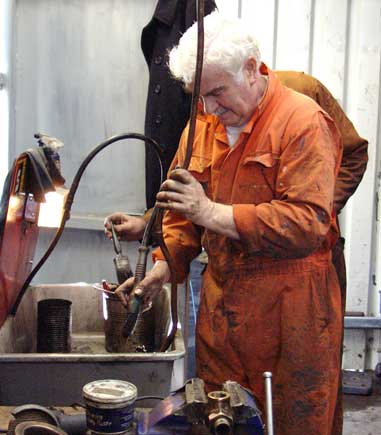 Bob Robson cleans some of the drain cock pipework. November 2 2003
