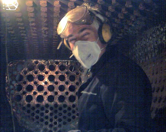 Chris Brown breaks off from needle gunning the crown stay nuts for a quick photo. Clear here is the copper firebox tubeplate March 8 2003 &copy; John Salter