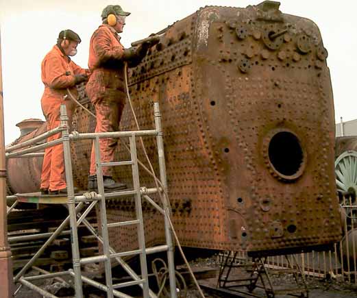 Dave Fuzard (left) and Leon Salter continue the needle gunning. March 1 2003 &copy; John Salter