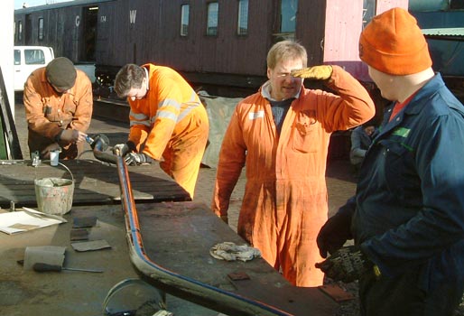 From the right Huw Button, Tim Watson, Richard Corser and Dave Fuszard demonstrate how many blokes are required to sort out a piece of brake pipe. January 17 2004 &copy; Colin Henderson