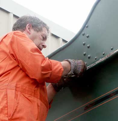 John Salter applies some anti-rust treatment to the tender. September 20 2003