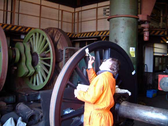 Kevin Blake paints white marks across the back of the tyre and wheel to enable us to detect any future tyre slip once the loco is back in service. March 16 2003. &copy; Colin Henderson