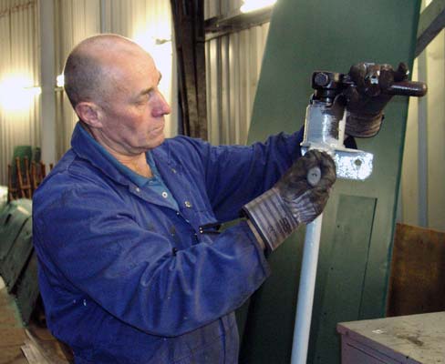Ron Smith paints one of the injector water valve controls. November 2 2003