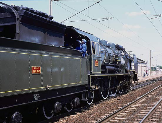 One of the loco crew gets a well earned drink of water on the footplate whilst the tender gets topped up with water as well. Note that the coal bunker contains both lump coal and coal briquettes. The locomotive burnt a combination of both. May 28 2003