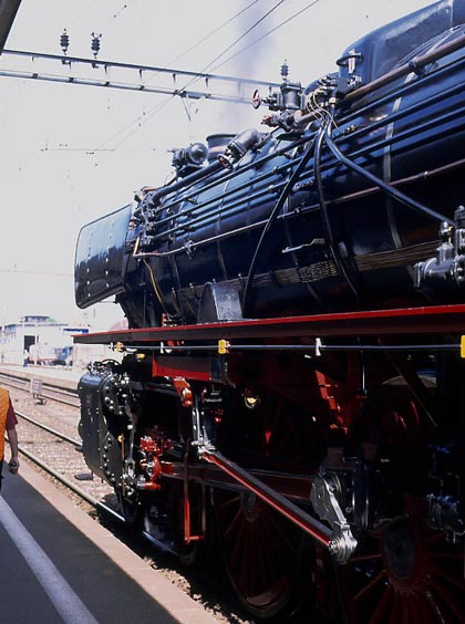 DB pacific 01 202 has plenty of bits and pieces of kit and pipework on the boiler including a series of beautifully laid out copper lubrication lines. The shed visible to the left of the locomotive is Burgdorf - home to 241A65. May 31 2003