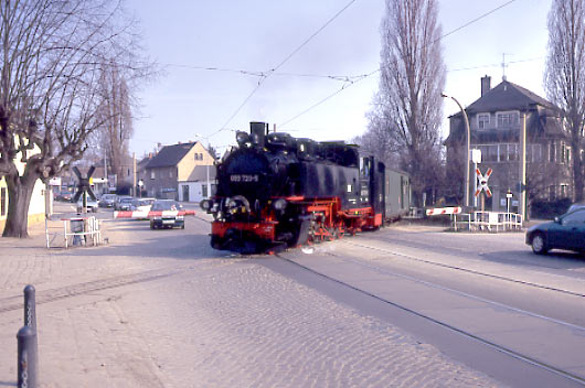 099 739-5 crosses the road and tramway at Weiss Ross. April 7 1996