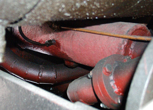 With less than ideal steam passages to the cylinders intermediate receivers have been fitted to each bogie. This is the large red item shown here. April 12 2004