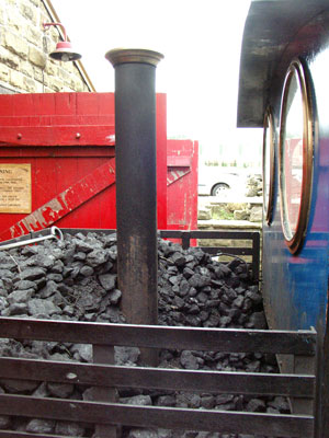 The rear chimney comes up through the coal bunker, below which is a small water tank feeding the left hand injector. As the exhaust goes straight to atmosphere the exhaust is often very wet as there is no mixing with the combustion gases to re-heat the exhaust steam. April 11 2004