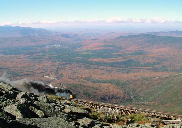 A view over a long wooden trestle with another heavily smoking locomotive heading uphill. October 14 2003 Courtesy of Nigel Day