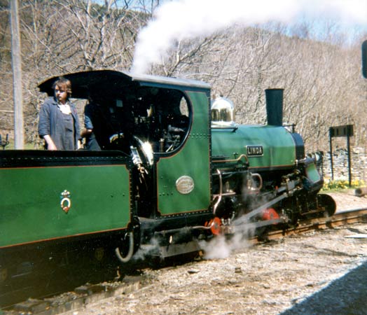 Linda in GPCS days at the head of a special train conveying the then General Manager of BR's London Midland Region. The driver is Seamus Rogers whilst fireman, looking back, is Shaun McMahon. The steam exhausting in front of the cab is from the vacuum ejector. Also note the ashpan and escaping clinker control steam. Taken at Tan-y-Bwlch in May 1986. © The late L.H.Murphy, courtesy of Shaun McMahon.