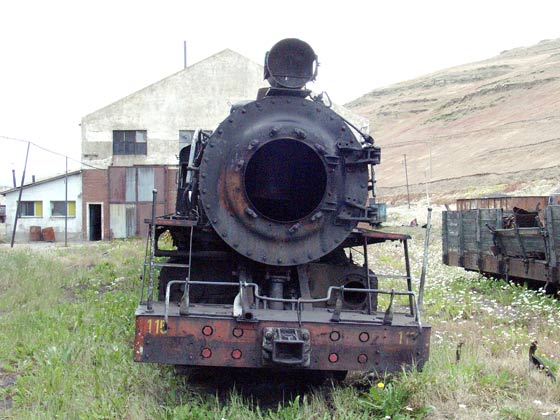RFIRT 115 is dumped behind the loco depot facing towards the town, as most of the locomotives are. Missing a few parts it appears to be leaning over some what ! January 23 2004