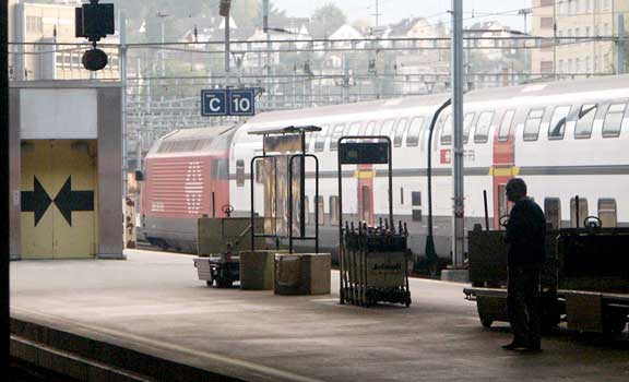 One of the very numerous Class 460 electrics stands at the head of a set of double deck carriages in Lucerne station. October 4 2003