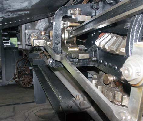 A view looking 'uphill' from under the cab toward the cylinders with the slide valve on the outside. Also visible is some of the mechanism to turn the drive thought 90&deg; and one of the two rack cogs. On the Pilatus Bahn the cental rack bar has the toothed edge facing outwards horizontally and not upwards as on all other lines. There are teeth on either side of the bar to each rack fitted vehicle has two cog wheels, one for either side of the bar. October 4 2003