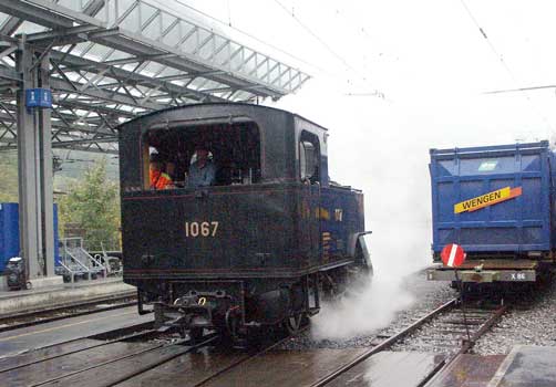 By Lauterbrunnen the weather had deteriorated ! Here 1067 runs round. On the right is a container destined for Wengen, via the Wengernalpbahn. Wengen can only be accessed by rail so all supplies have to come in by train. October 5 2003