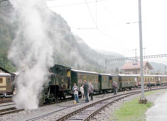 The first water stop was in the loop at junction station Zweilütschinen. Here the line splits for Grindelwald or Lauterbrunnen. 1067 takes water as the passengers wander around and avoid getting mowed down. October 5 2003