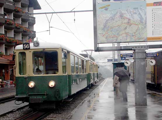 Grindelwald is the interchange for the 800mm gauge Wengernalpbahn. The line leads over the mountains to the afternoon destination of Lauterbrunnen. Here train 56 for Kleine Scheidegg sets off in the rain. October 5 2003