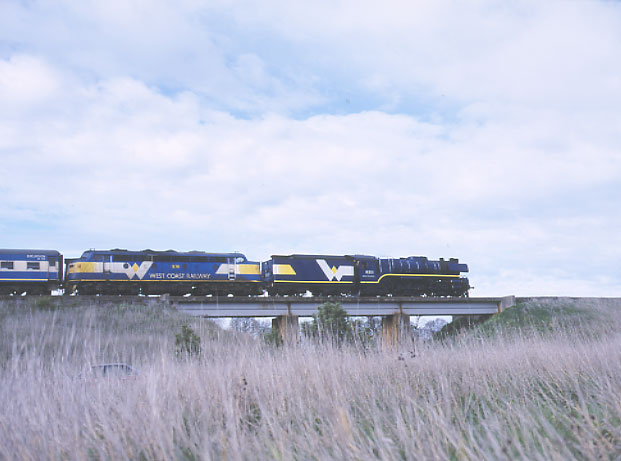 In "multiple unit" on the Saturday morning service to Warrnambool, R 711 and B 76 cross the Mt Emu Creek bridge between Boorcan and Terang. 4.8.2001. MARTYN BANE