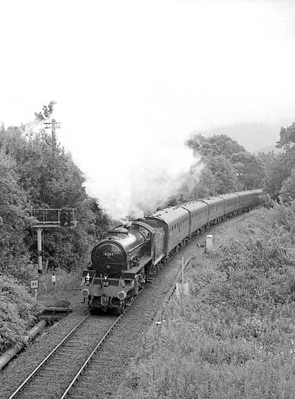 Just about the last move of the day is hauling the empty stock out to Fort William depot. Here 61264 gets away from Fort William station. July 8 2003