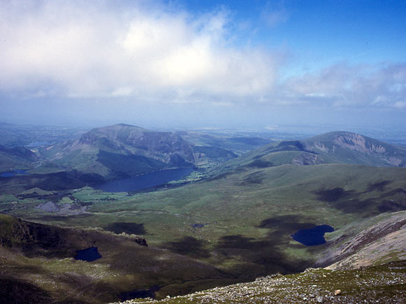 This is the view from the summit station looking west. The lake in the middle distance is Llyn Cwellyn. On the far side of the slade tips on the left runs the Welsh Highland Railway. July 12 2003