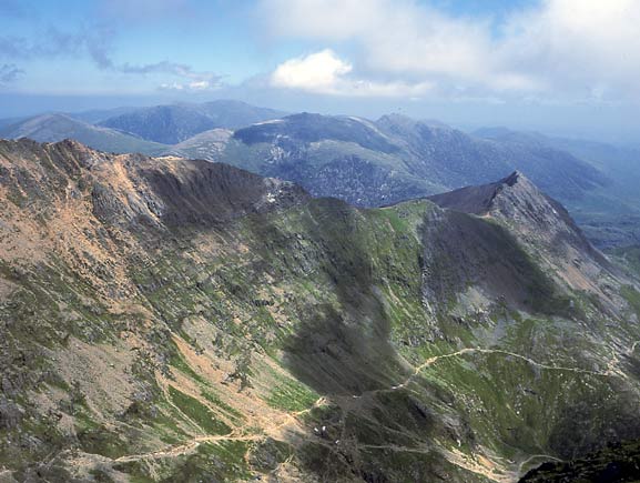 This view from Snowdon summit shows the perilous Crib Goch ridge. Lower down the two walking routes visible are the Pyg Track (the higher of the two) and the Miners Track. July 12 2003
