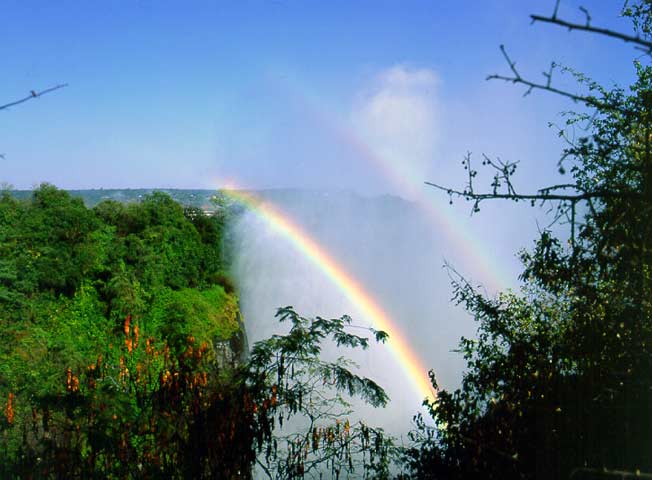 A pair of rainbows in the spray from Victoria Falls. May 1997