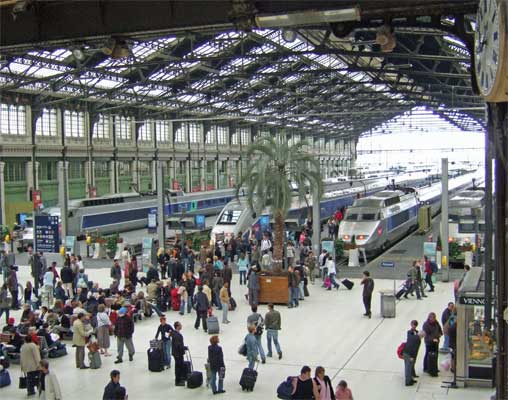Paris Gare de Lyon with 3 TGVs under the roof. There are further sections of the station either side of the platforms in view.