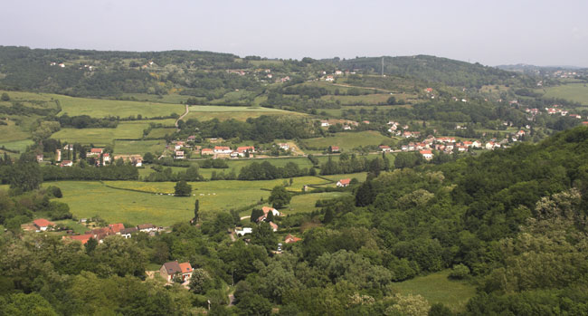 The line from Nevers is hidden by the trees in the foreground but is down in the valley just behind the closest house. The wooded hill to the right contains the summit tunnel. &copy; Brian Bane 