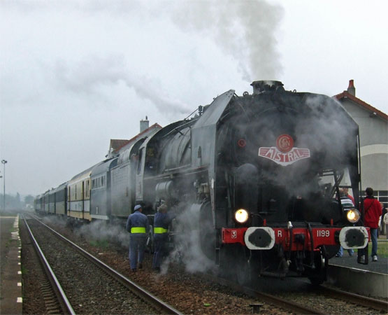 No.1199's support crew check around as the loco takes water at Cercy-la-Tour. Thankfully the weather was about to change for the better!