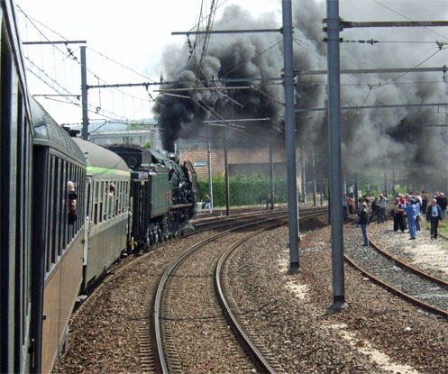 From no exhaust to this in a few seconds - presumably the stoker had been turned on! 241P17 does its best to engulf Tournon in thick black smoke. Not a very good advert for steam in the 21st century. Plenty of people turned out to see us leave Tournon and, again, were all over the track.