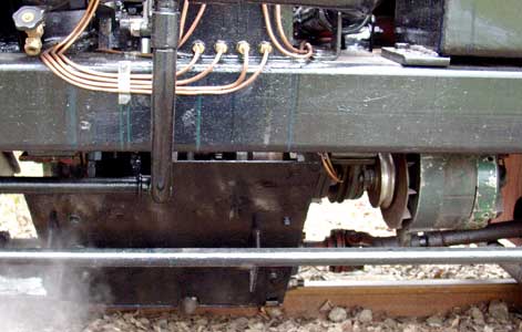 The large black cover below the frames contains the drive chain to the carden shafts seen emerging from either side. Also note the alternator. April 11 2004